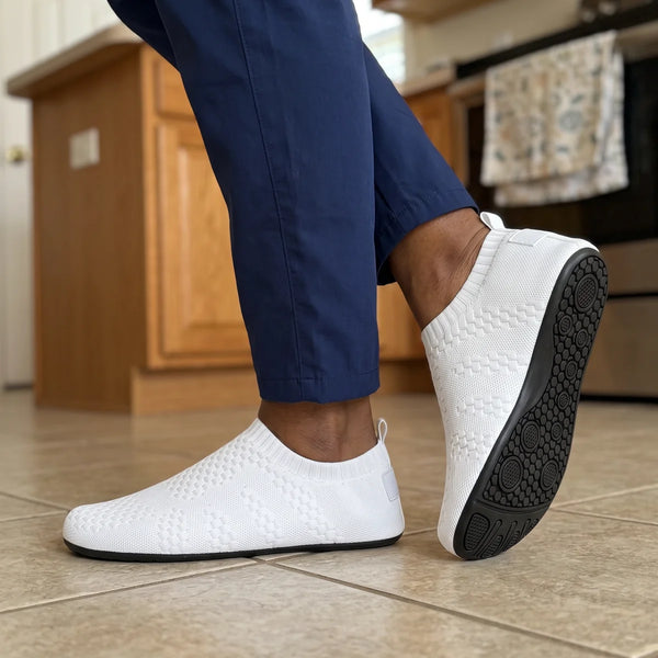 White Cloud Sock Shoes on a kitchen tile floor, showing the rubber grip sole