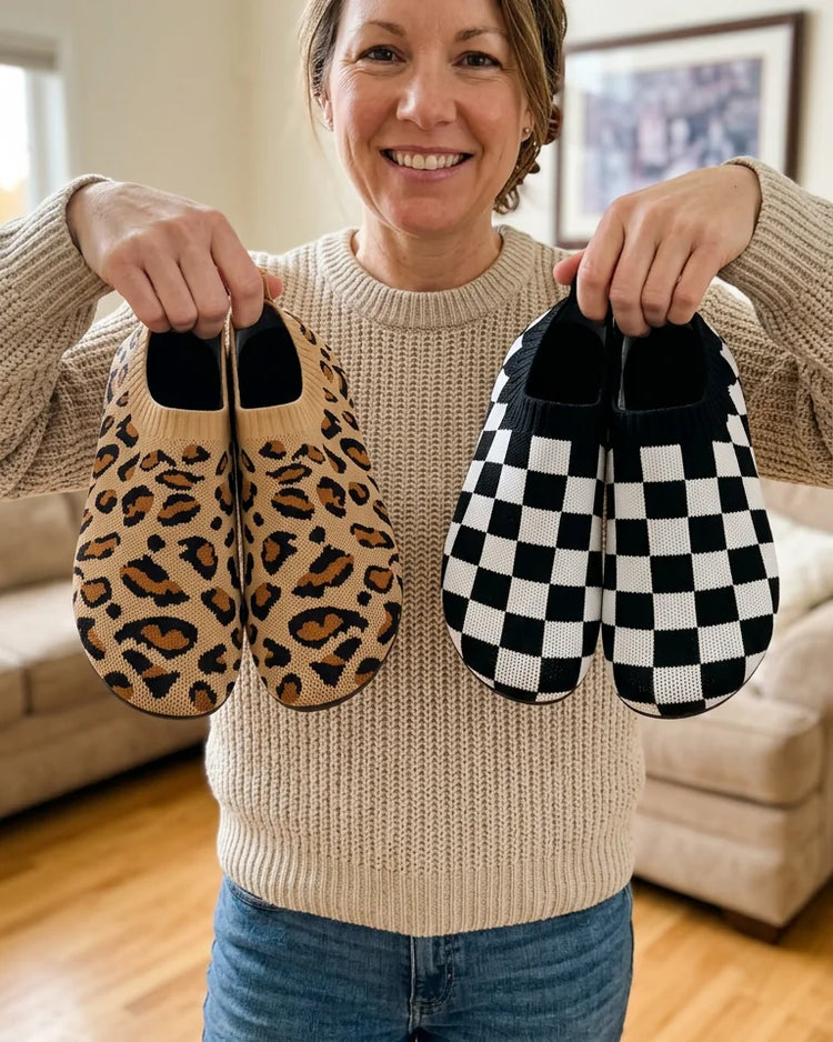 Smiling woman holding two pairs of Cloud Sock Shoes, leopard and checkered