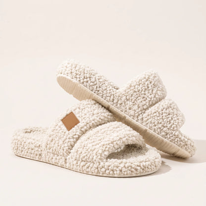 Fuzzy two-strap slides in Cream, studio shot showing the low cream sole