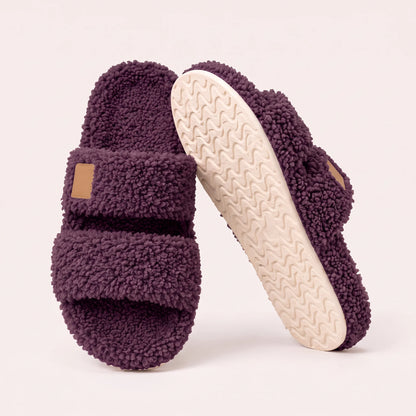 Fuzzy two-strap slides in Plum, one flat and one tilted to show the wavy cream sole